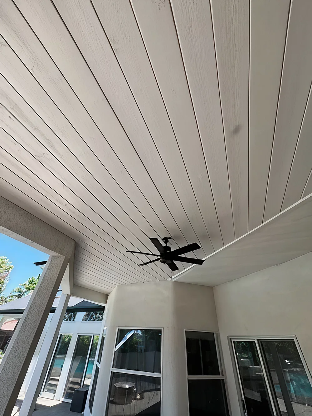 Patio ceiling upgrade with white shiplap panels and fan
