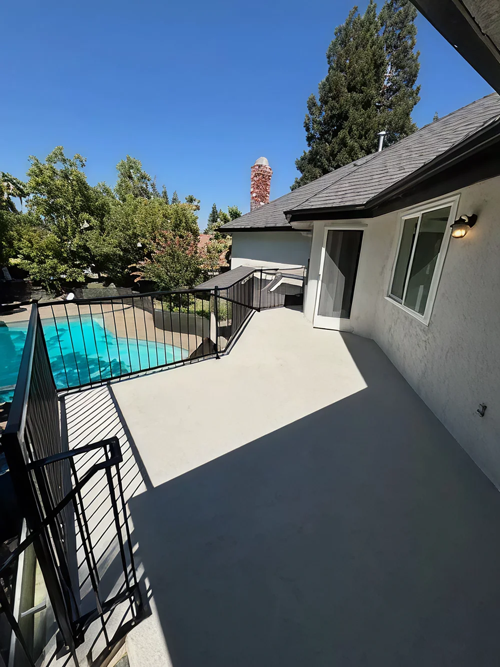 Patio flooring upgrade with fresh coating overlooking pool